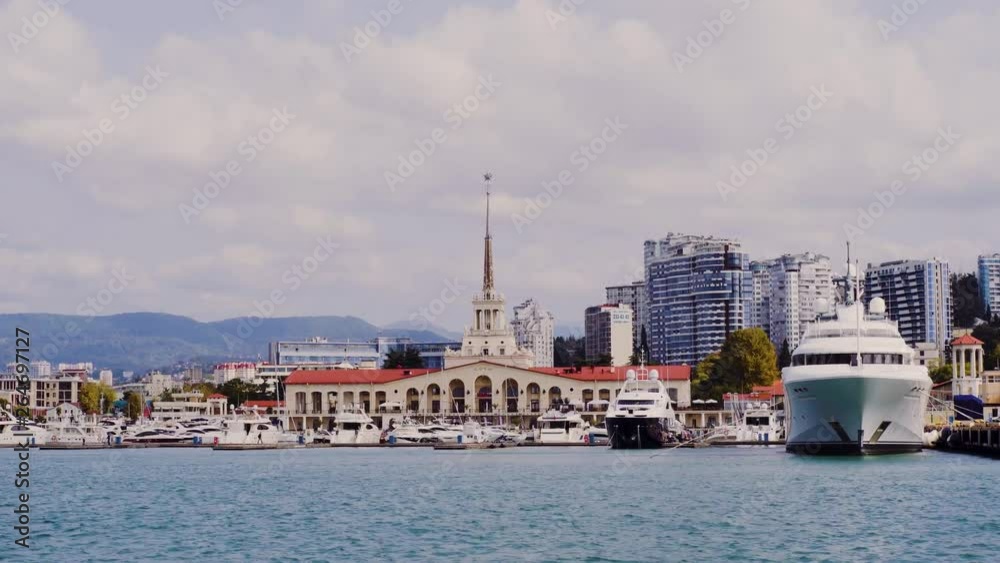 Sochi- 04.30.2019: Sea terminal of the city of Sochi with moored yachts and boats on a summer sunny day. The building of the Sochi Marine Station. Sochi- 04.30.2019: Sea terminal of the city of Sochi with moored yachts and boats on a summer sunny day. The building of the Sochi Marine Station.