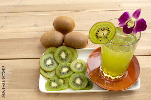 kiwi juice with lime on wood background