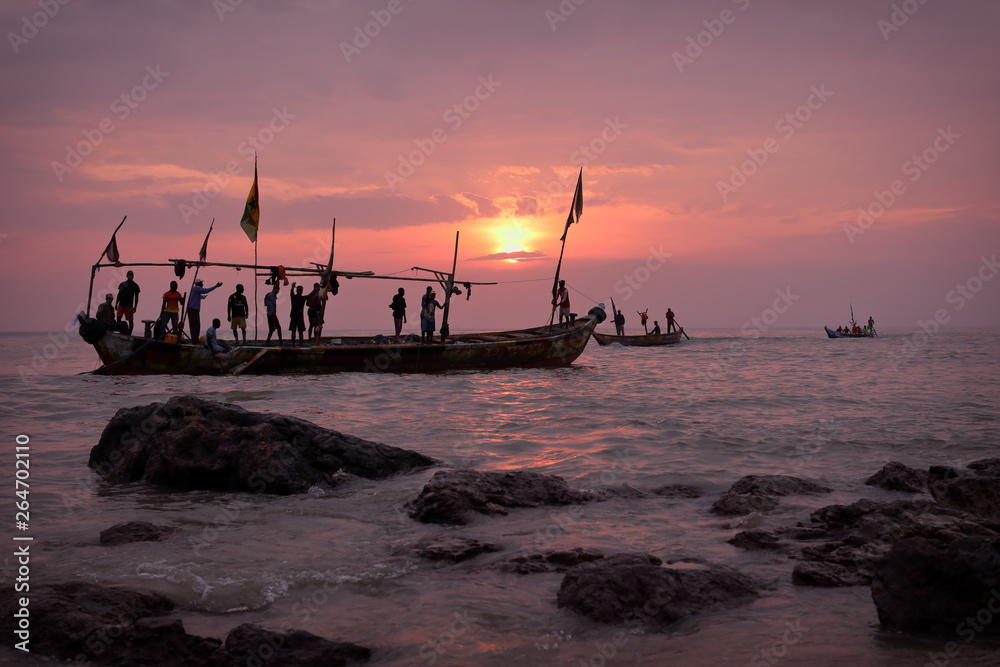 Fishing boat and fishermen at sunrise in Senya Beraku, Ghana