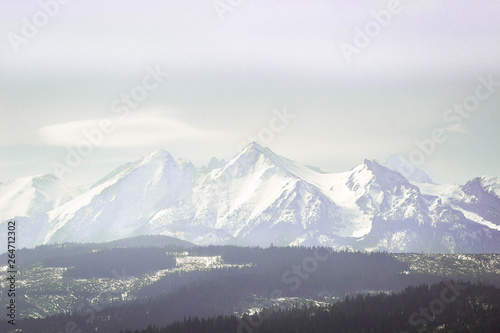 Snowy mountaing peaks of Tatra wrapped in a slight fogg