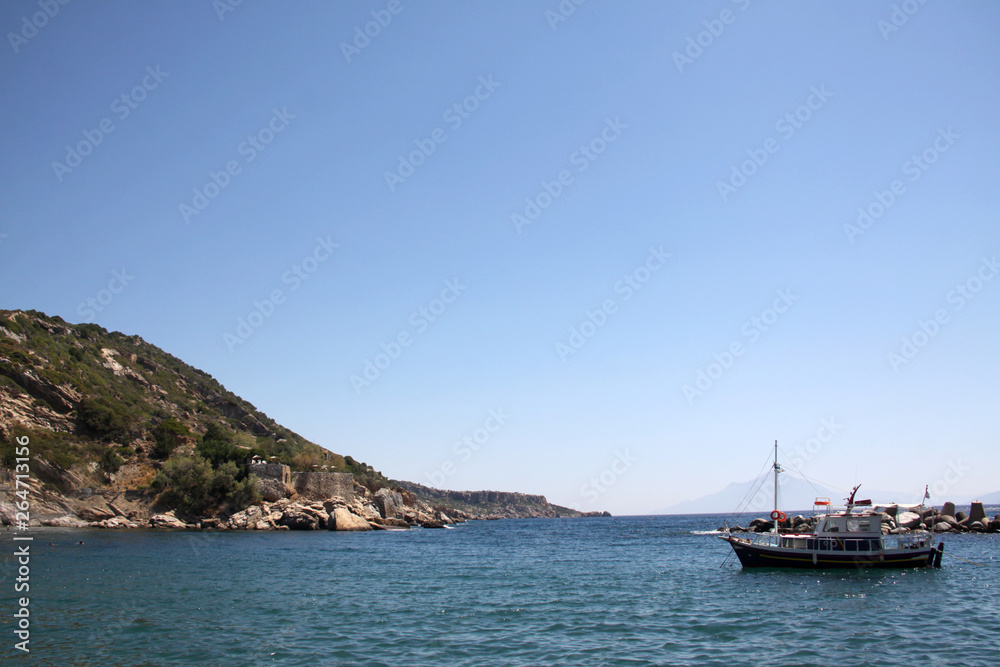 Boat in the Aegean sea. Beautiful view. The background of the sea. The concept of tourism and travel on the water
