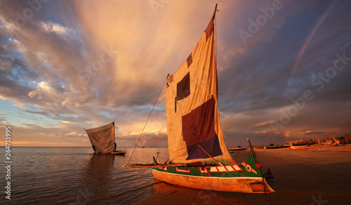 Traditional fishing pirogue at sunset with dramatic sky after a thunderstorm in Anakao, Madagascar