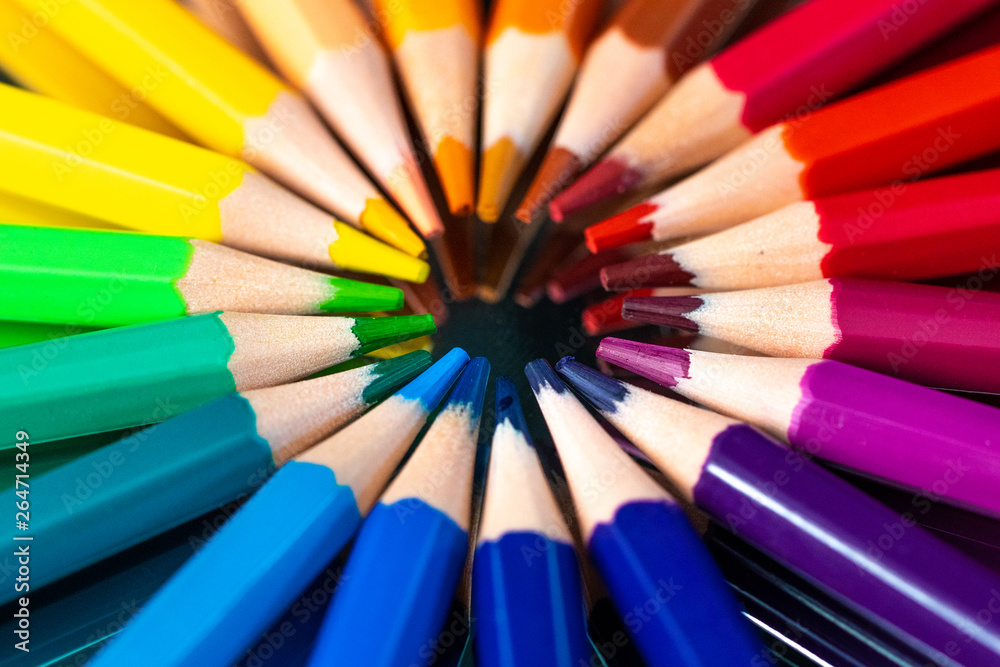 Many different colored pencils reflected on black Many different colored pencils reflected on black