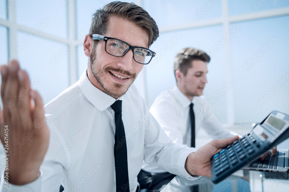 young accountant holding a thumb up and smiling young accountant holding a thumb up and smiling