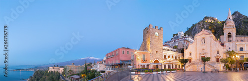 Taormina - The square Piazza IX Aprile and St. Joseph church  Porta di Mezzo gate and Mt. Etna volcano in the background.
