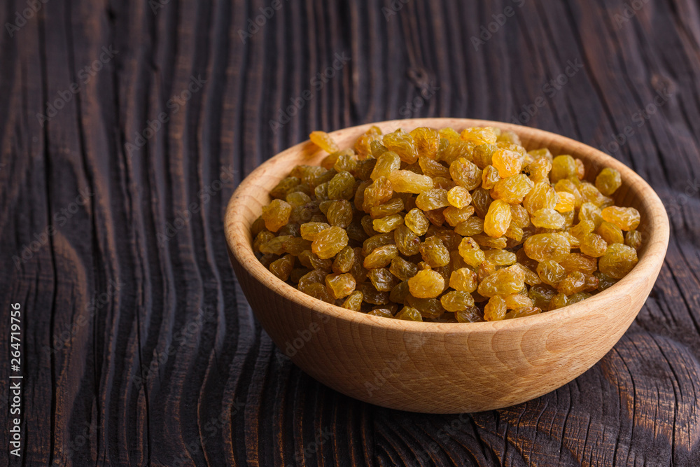 golden raisins on a wooden rustic background golden raisins on a wooden rustic background