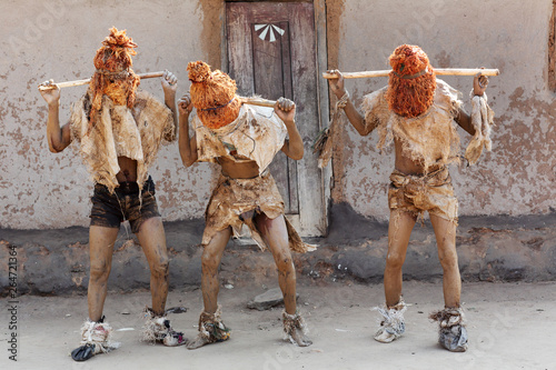 Traditional Nyau dancers with face masks at a Gule Wamkulu ceremony in a small village near Lilongwe, Malawi photo