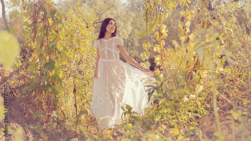 Portrait of a girl in a white dress on nature