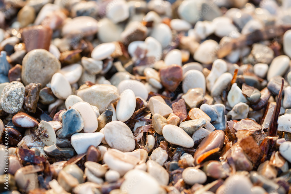Close up beach stones on the seashore. Summer sunrise on coast, Corfu island, Greece. Beach Ionian sea. Wallpaper Close up beach stones on the seashore. Summer sunrise on coast, Corfu island, Greece. Beach Ionian sea. Wallpaper