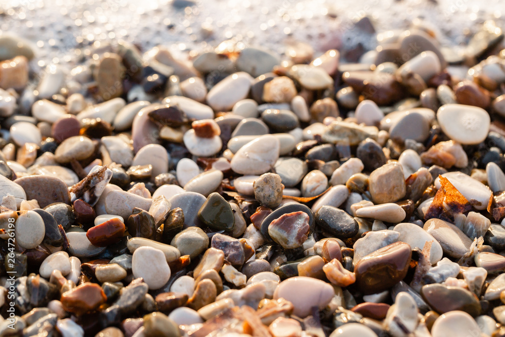 Close up beach stones on the seashore. Summer sunrise on coast, Corfu island, Greece. Beach Ionian sea. Wallpaper Close up beach stones on the seashore. Summer sunrise on coast, Corfu island, Greece. Beach Ionian sea. Wallpaper