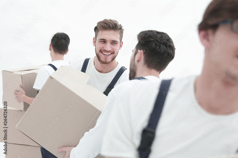 Photo workers pass each other boxes when moving flats. Photo workers pass each other boxes when moving flats.