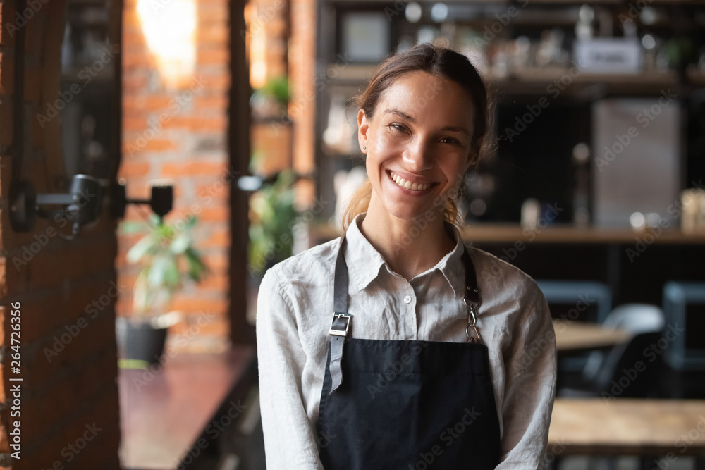 © fizkes - Happy mixed race female in apron smiling looking at camera © fizkes - Happy mixed race female in apron smiling looking at camera