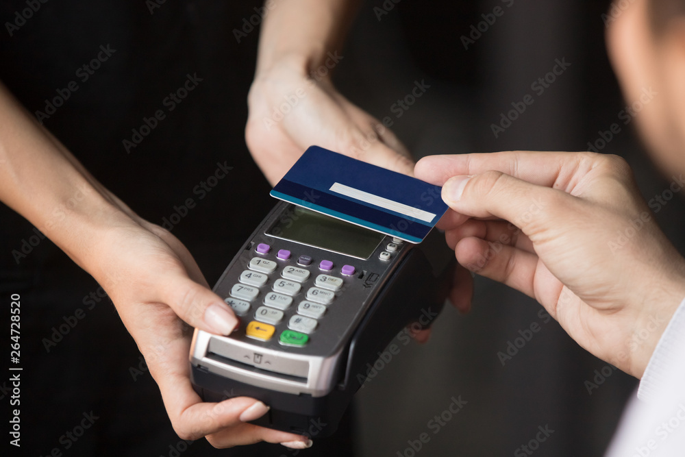 Customer paying in cafe with credit card use NFC technology Customer paying in cafe with credit card use NFC technology
