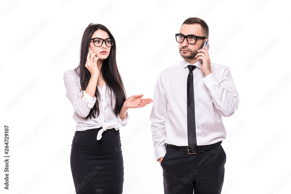 Portrait of a confident young business couple talking on mobile phone isolated over white background. Portrait of a confident young business couple talking on mobile phone isolated over white background.