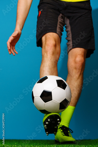 Soccer player with ball on the green grass. © nuclear_lily