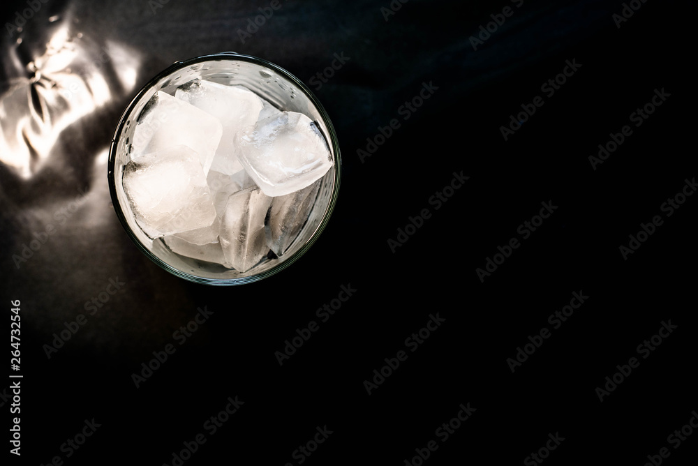 Ice in a glass on a black background