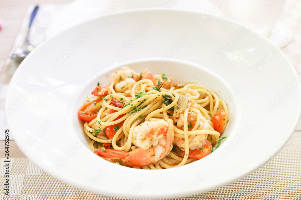 Spaghetti shrimp scampi with garlic,olive oil and chili on white plate. Spaghetti shrimp scampi with garlic,olive oil and chili on white plate.