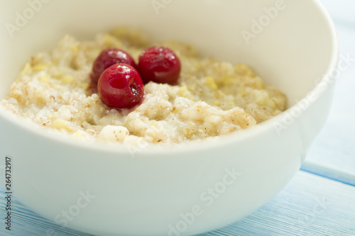 Tasty fresh breakfast . Oatmeal with frozen cherry . tasty and healthy breakfast concept