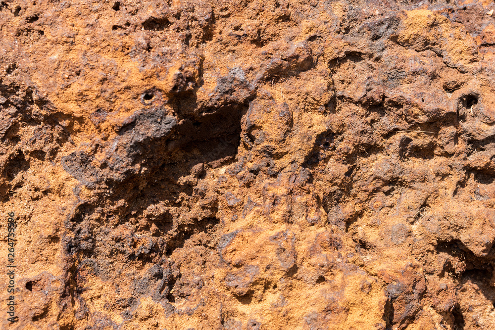 Fototapeta premium Natural volcanic stone in red and brown. Surface of the volcanic rock