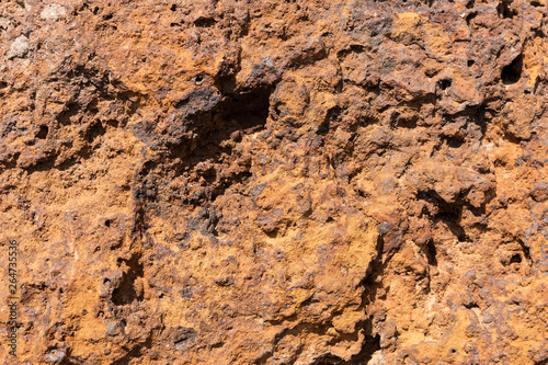 Natural volcanic stone in red and brown. Surface of the volcanic rock