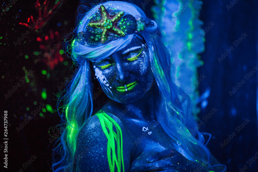 Portret of Water woman.  Body art glowing in ultraviolet light