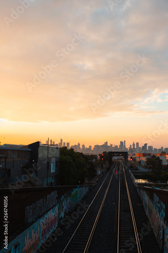 Melbourne CBD skyline with railroad track morning view with cloudy sky.
