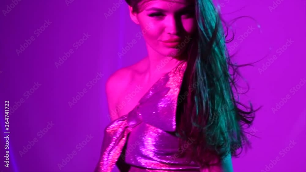Hot model girl dancing in UV neon lights. Disco party. Sexy young woman with long hair dancing. Night life. Slow Motion 4K UHD video footage. 3840X2160 Hot model girl dancing in UV neon lights. Disco party. Sexy young woman with long hair dancing. Night life. Slow Motion 4K UHD video footage. 3840X2160
