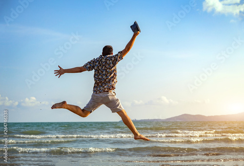 happy man freedom jump ocean sea scape background