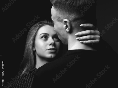 Young woman and young man in studio. Couple. Black and white.