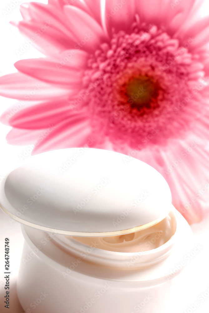 white jar with cosmetics cream and pink gerbera daisy flower like wellness, beauty, spa, and body care, skinconcept white jar with cosmetics cream and pink gerbera daisy flower like wellness, beauty, spa, and body care, skinconcept