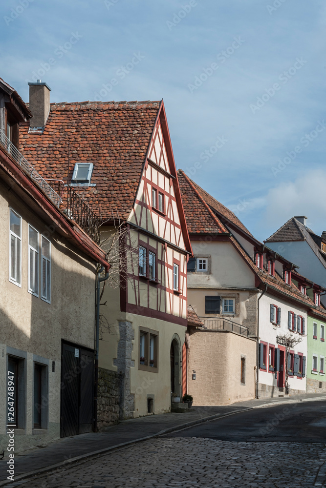 ROTHENBURG OB DER TAUBER, GERMANY - MARCH 05, 2018: Historic colorful half-timbered houses in the medieval town Rothenburg ob der Tauber, one of the most beautiful villages in Europe, Germany ROTHENBURG OB DER TAUBER, GERMANY - MARCH 05, 2018: Historic colorful half-timbered houses in the medieval town Rothenburg ob der Tauber, one of the most beautiful villages in Europe, Germany