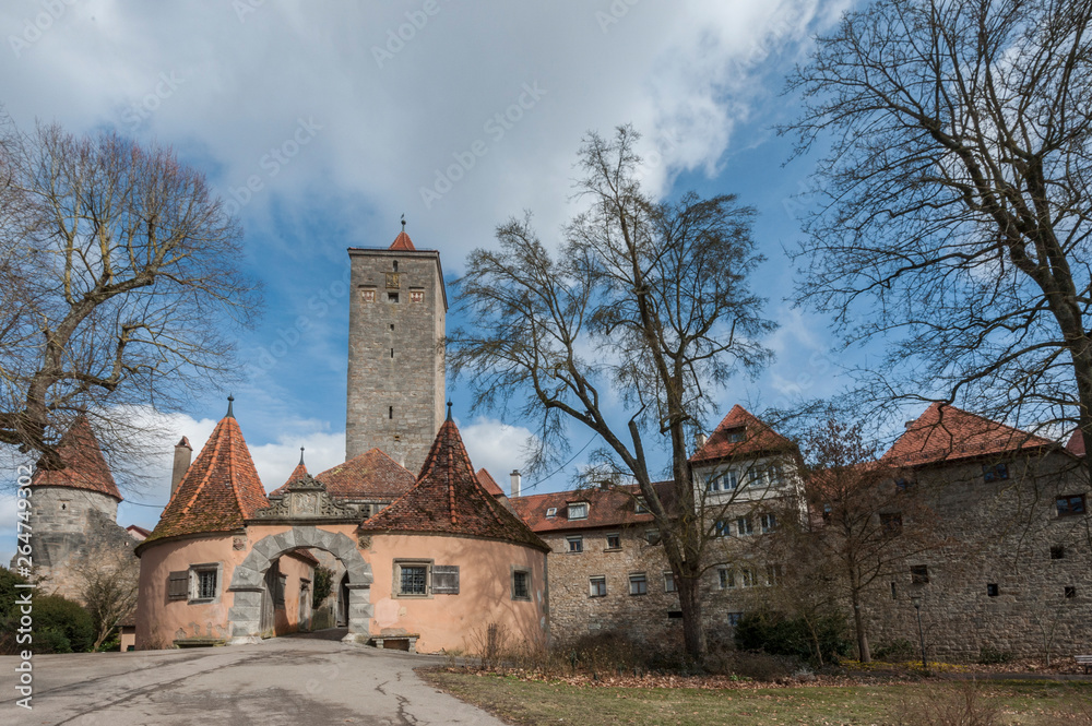 Fototapeta premium Castle tower and city gate at the entrance to the old town of Rothenburg ob der Tauber, one of the most beautiful and romantic villages in Europe, Germany
