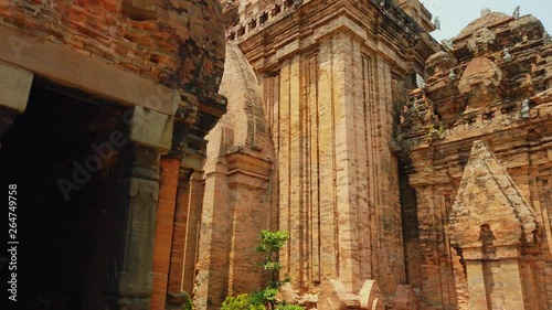 Gimbal close up stone red entrance orange old temple Vietnam Nha Trang ruin nobody. Authentic culture Asia. Unusual landmark heritage ancient unique architecture. Sunny day. Travel tourism. Dolly photo