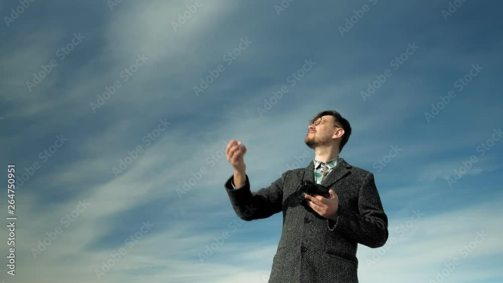 man controls quadcopter outdoors man controls quadcopter outdoors