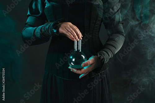 woman is a research scientist holding a flask with the material. Concept of scientific research and history of science.