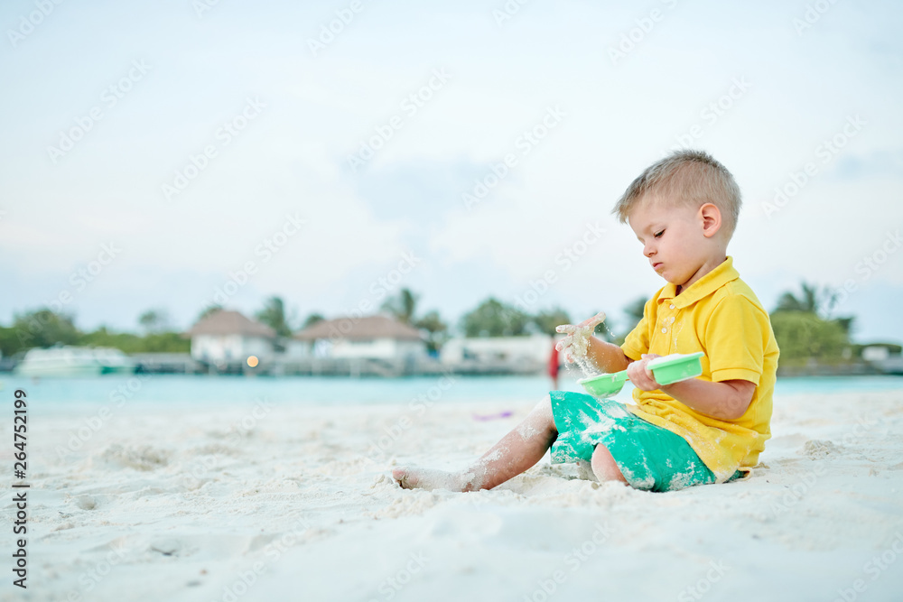 Three year old toddler playing on beach Three year old toddler playing on beach