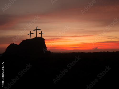 Silhouette of three crosses on hill at sunset. Religion Crucifixion Of Jesus Christ.