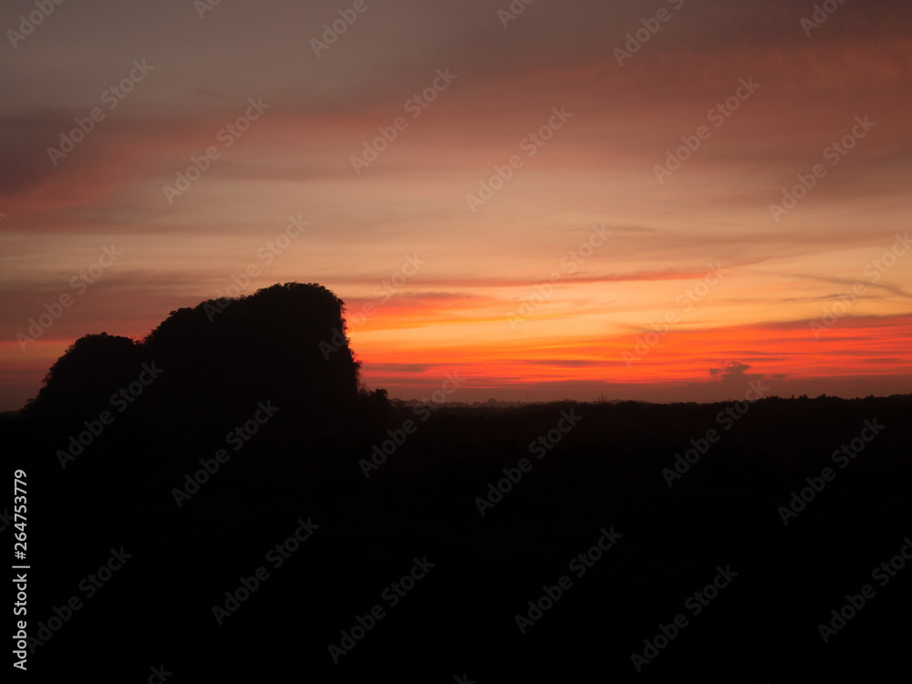 Silhouette mountain hill at sunrise sunset gold orange yellow sky and clouds. Silhouette mountain hill at sunrise sunset gold orange yellow sky and clouds.