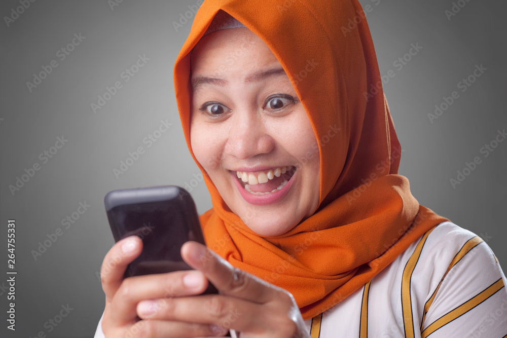 Young Muslim Woman Get Good News on Her Phone Young Muslim Woman Get Good News on Her Phone