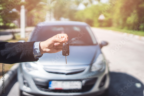 Hand of business man gives the car key