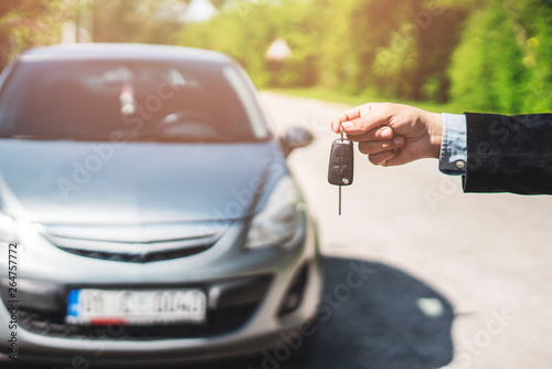 Hand of business man gives the car key