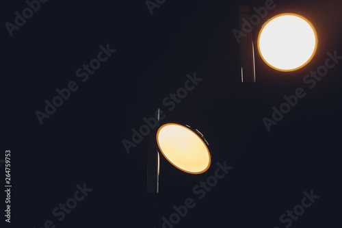 Two incadescent light bulbs in an industrial lamp. Dark environment. Concept of idea. Copy space on the left. photo