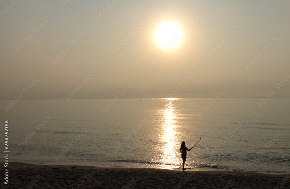 Girl taking fun selfie picture on beach vacation. Summer holiday woman happy at smartphone camera taking self-portrait