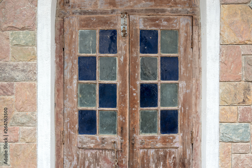 Vintage architecture wooden door decorated with colorful stained glass