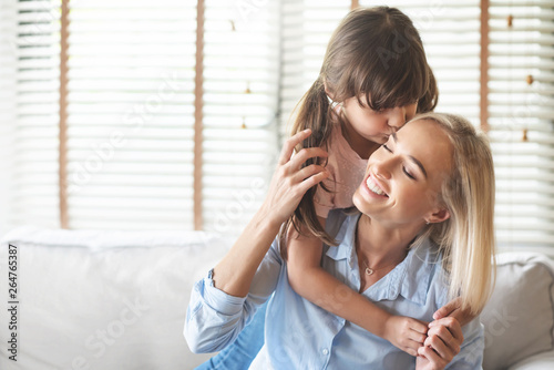 Daughter kissing on her Mom forehead