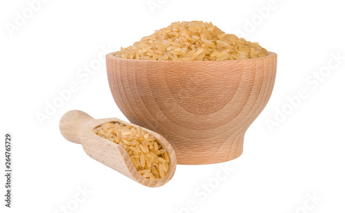 brown rice in wooden bowl and scoop isolated on white background. nutrition. bio. natural food ingredient.front view.