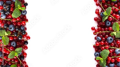 Mix berries on a white background. Ripe red currants  black currants  blueberries on white background. Top view. Fruits at border with copy space for text. Mix berries and fruits.