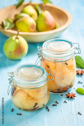 Natural and juicy pickled pears on wooden table