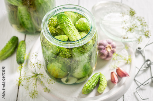 Closeup of fresh pickled green cucumber on white table