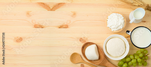 Milk and cheese, dairy products on wooden table background.